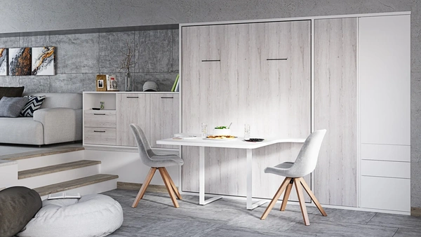 Diseño minimalista de habitación con una cama abatible vertical y una mesa de comedor elegante, proporcionando una solución de ahorro de espacio y multifuncionalidad para viviendas contemporáneas.